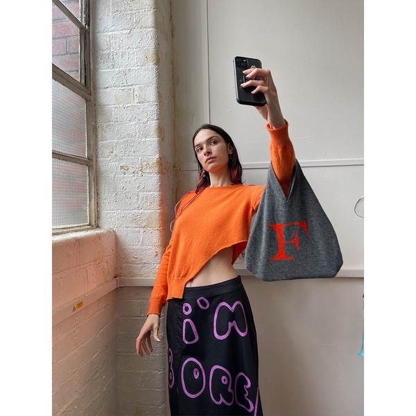 Model wearing HADES F bag taking a selfie