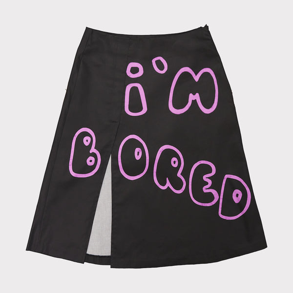 Front flat shot of the 'I'm Bored' skirt in black and pink