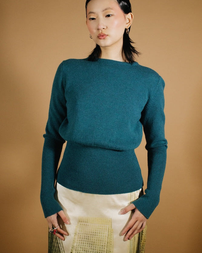 A model image wearing the Edie knit and Metropolis Skirt.