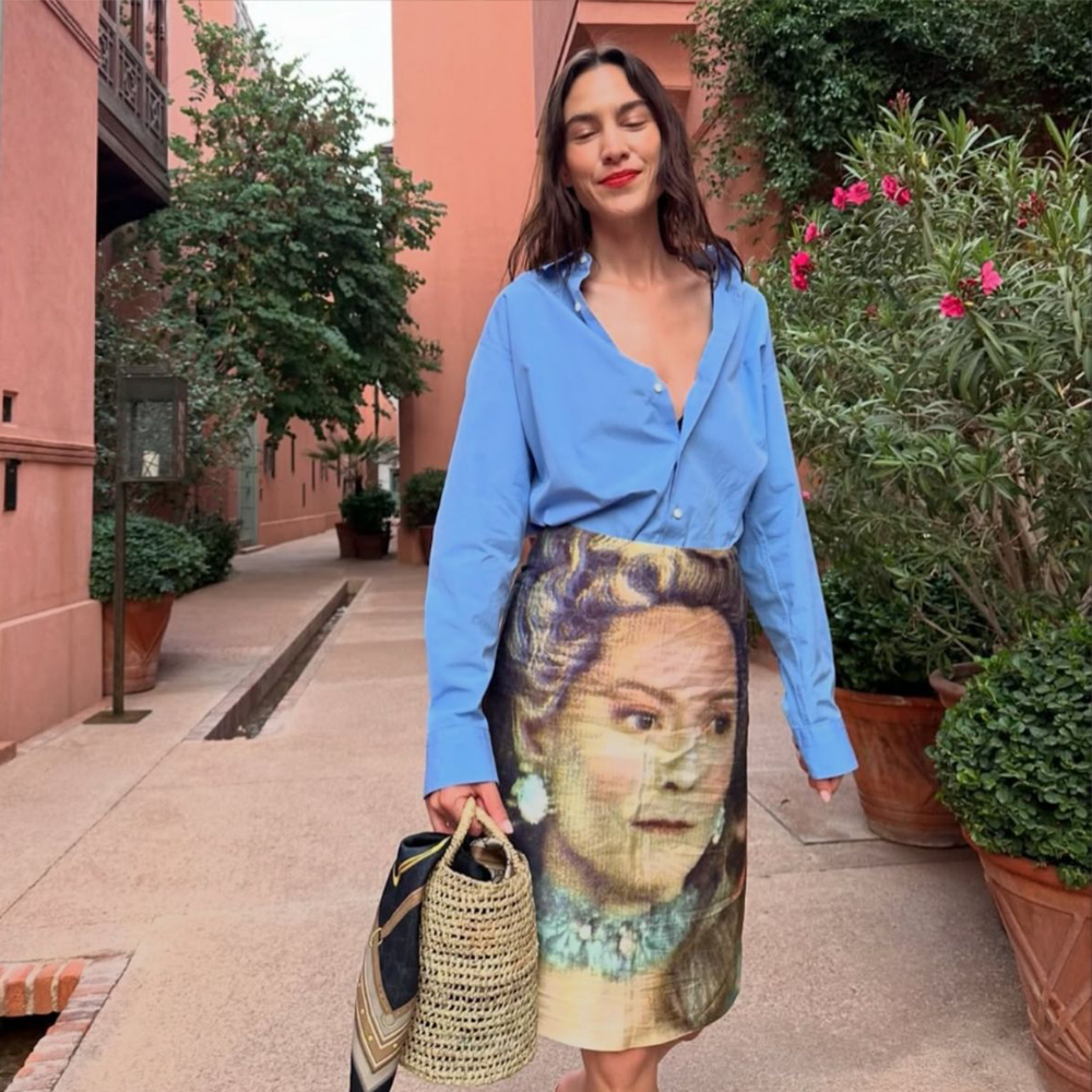 Alexa Chung wearing the Orlando Skirt with a blue shirt on holiday.