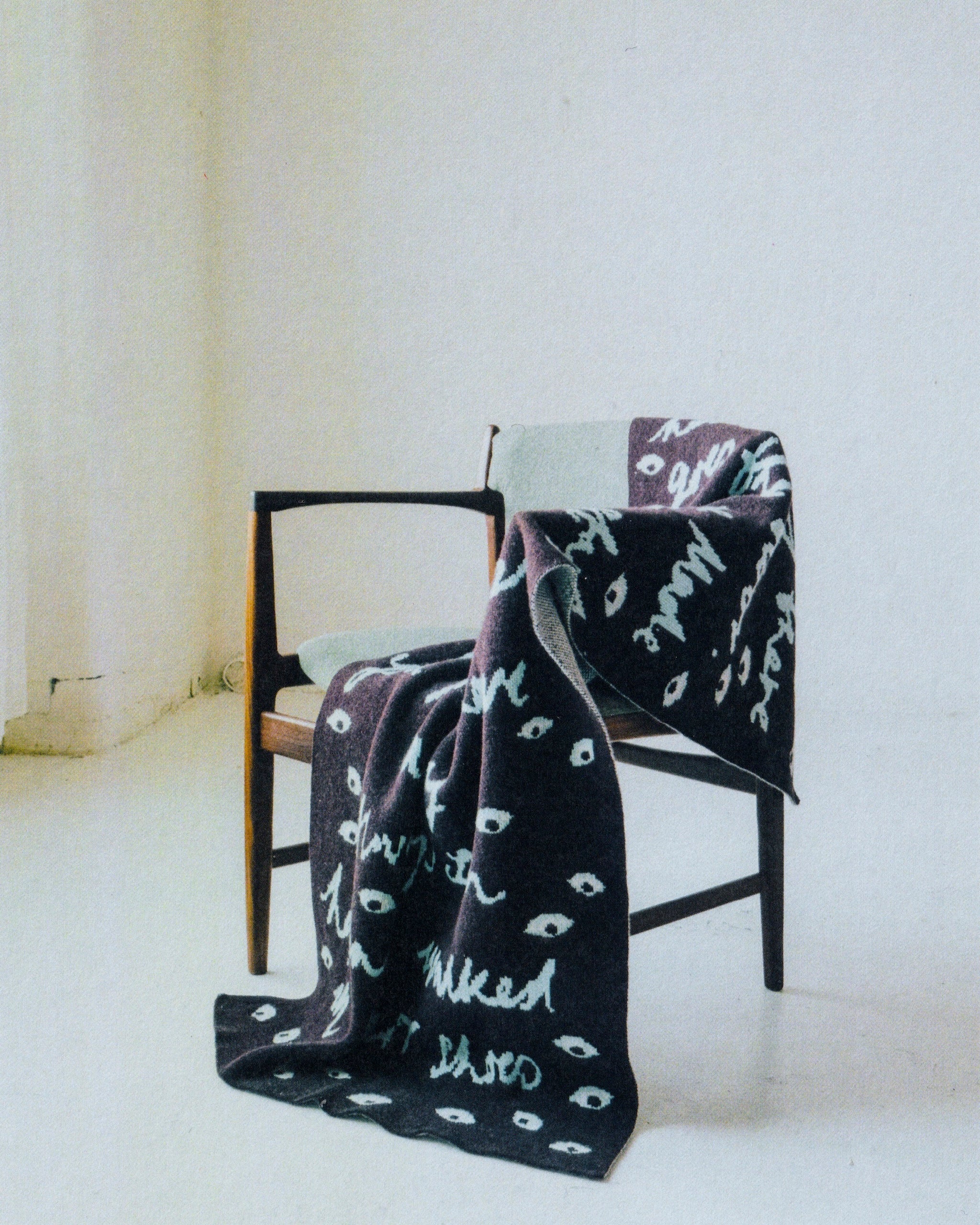 Image of the Women in Prison Blanket draped over a chair 