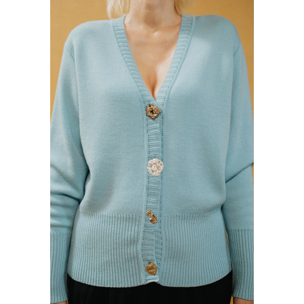 HAES 138 cardigan worn by model. Light blue cardigan with decorative buttons.