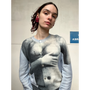 Person wearing a sweater with a graphic design of a torso.