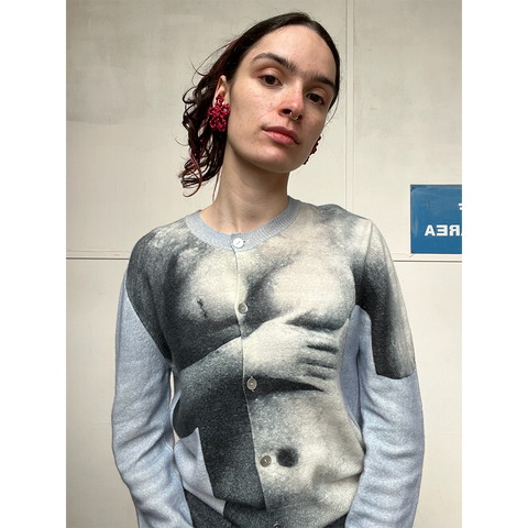 Person wearing a sweater with a graphic design of a torso.