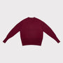 The back of a long-sleeve knit cardigan in a deep burgundy color, laid flat against a light gray background.