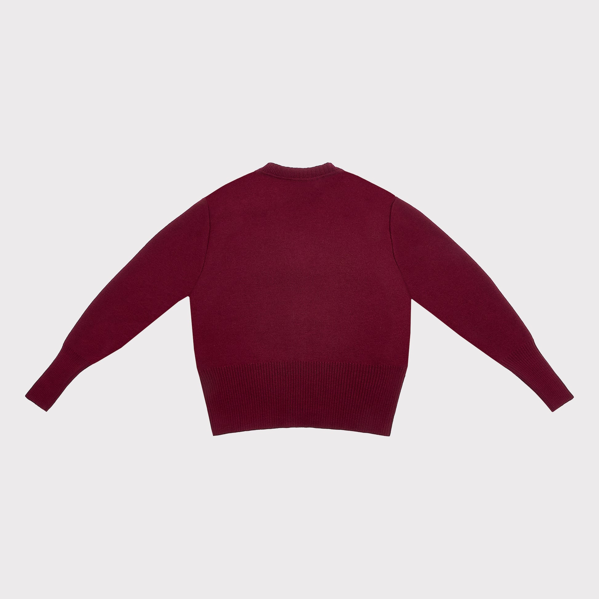 The back of a long-sleeve knit cardigan in a deep burgundy color, laid flat against a light gray background.