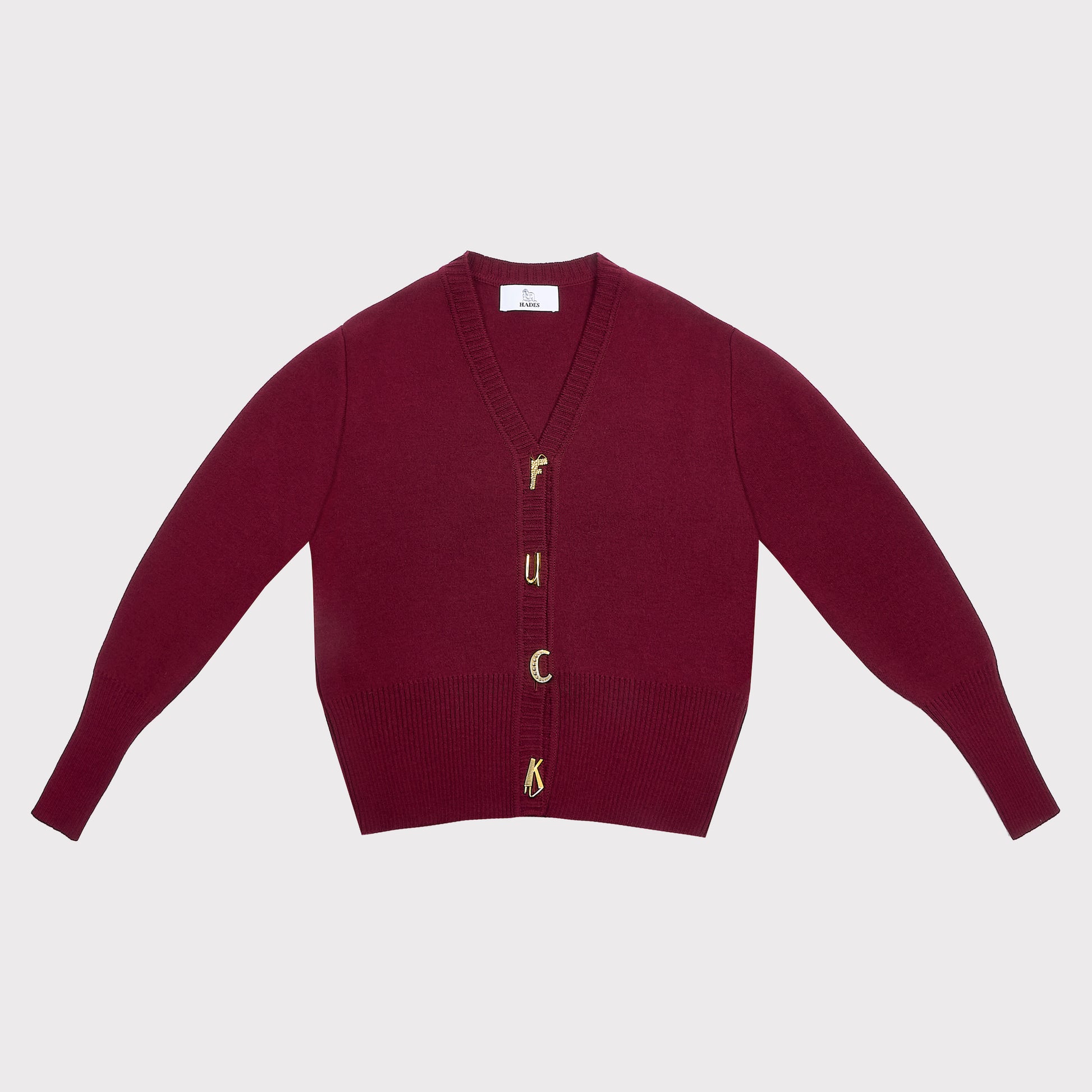 A maroon knit cardigan with long sleeves and gold-tone letter buttons spelling 'F**K' on the front, displayed flat against a light gray background.