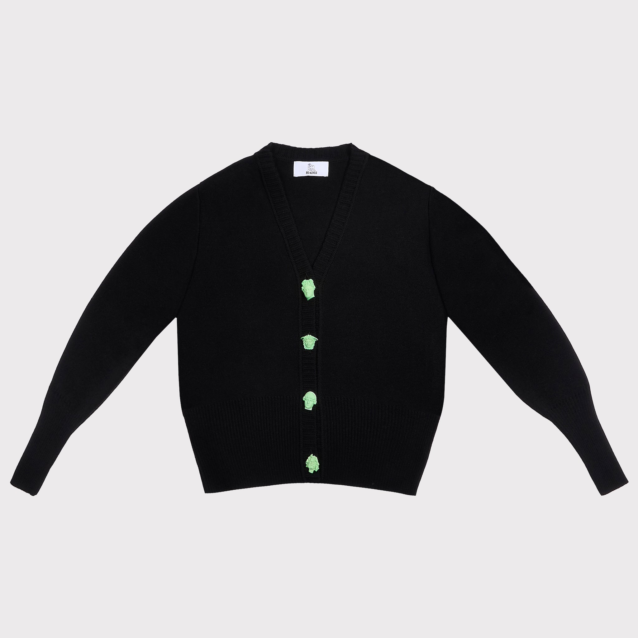 A black knit cardigan sweater with long sleeves featuring four light green decorative Greek Mythology buttons down the front, laid flat against a light gray background.