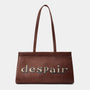 A dark brown leather bag with long shoulder straps and the word 'despair' printed in a light beige serif font across the front, set against a plain light gray background.