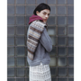 Image of a model wearing the Fair Isle Berry & Brown Hooded scarf and the HADES Armour Knit and the HADES HADES HADES skirt.