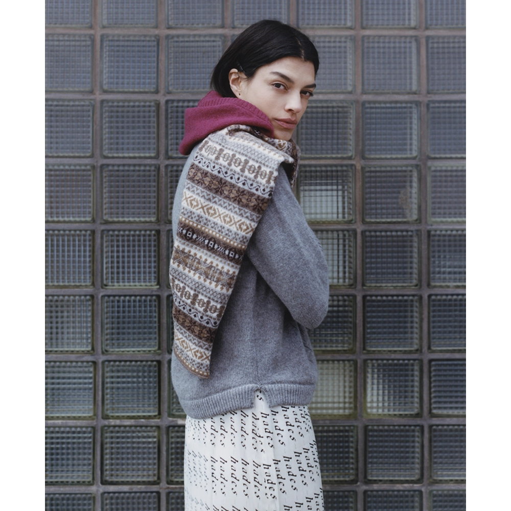 Image of a model wearing the Fair Isle Berry & Brown Hooded scarf and the HADES Armour Knit and the HADES HADES HADES skirt.