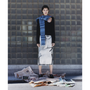 Image of a model wearing the Fair Isle Burnt Organge & Blue Hooded scarf and the HADES Selavy Black Knit and the HADES Ordinary Happiness skirt.