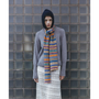 Image of a model wearing the Fair Isle Navy & Multi-Coloured Hooded scarf, the HADES Armour Knit, and the HADES HADES HADES skirt.