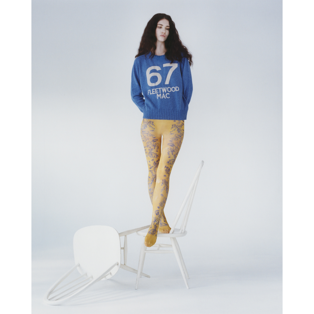 A model standing on a chair wearing the 1967 Fleetwood Mac knit.