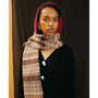 Image of a model wearing the Fair Isle Berry & BrownHooded scarf and the HADES Greek Mythology Knit.