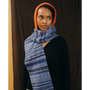 A model wearing the Burnt Orange & Blue Hooded scarf and the Greek Mythology cardigan.