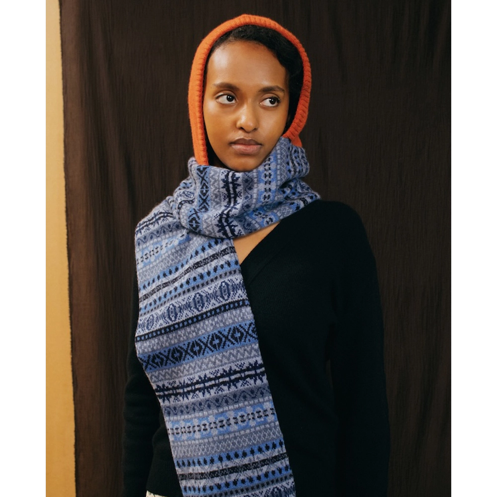 A model wearing the Burnt Orange & Blue Hooded scarf and the Greek Mythology cardigan.