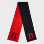 A double-sided scarf in red and black, featuring a large black letter 'B' on the red side and a red letter 'B' on the black side, laid flat on a light grey background.