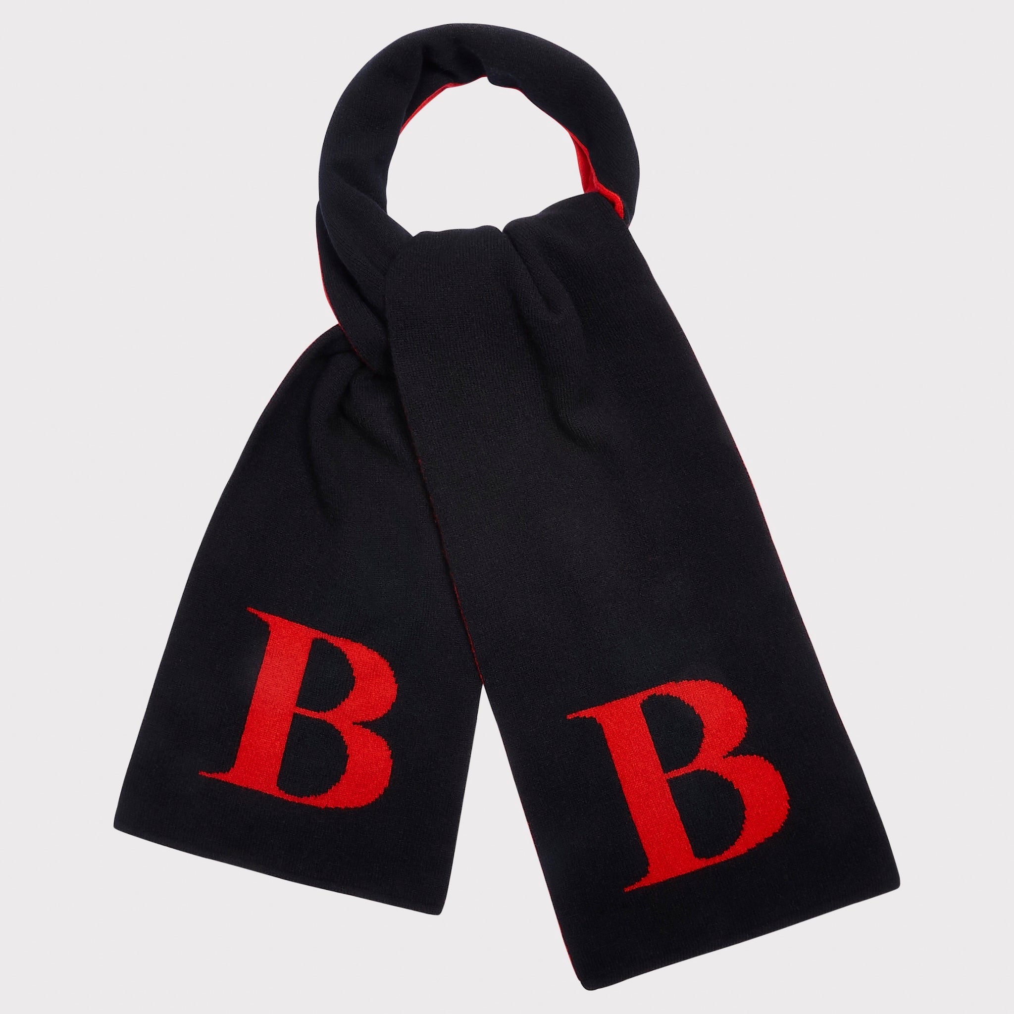 A black knit scarf with a red letter 'B' on each end, shown tied on a light grey background.