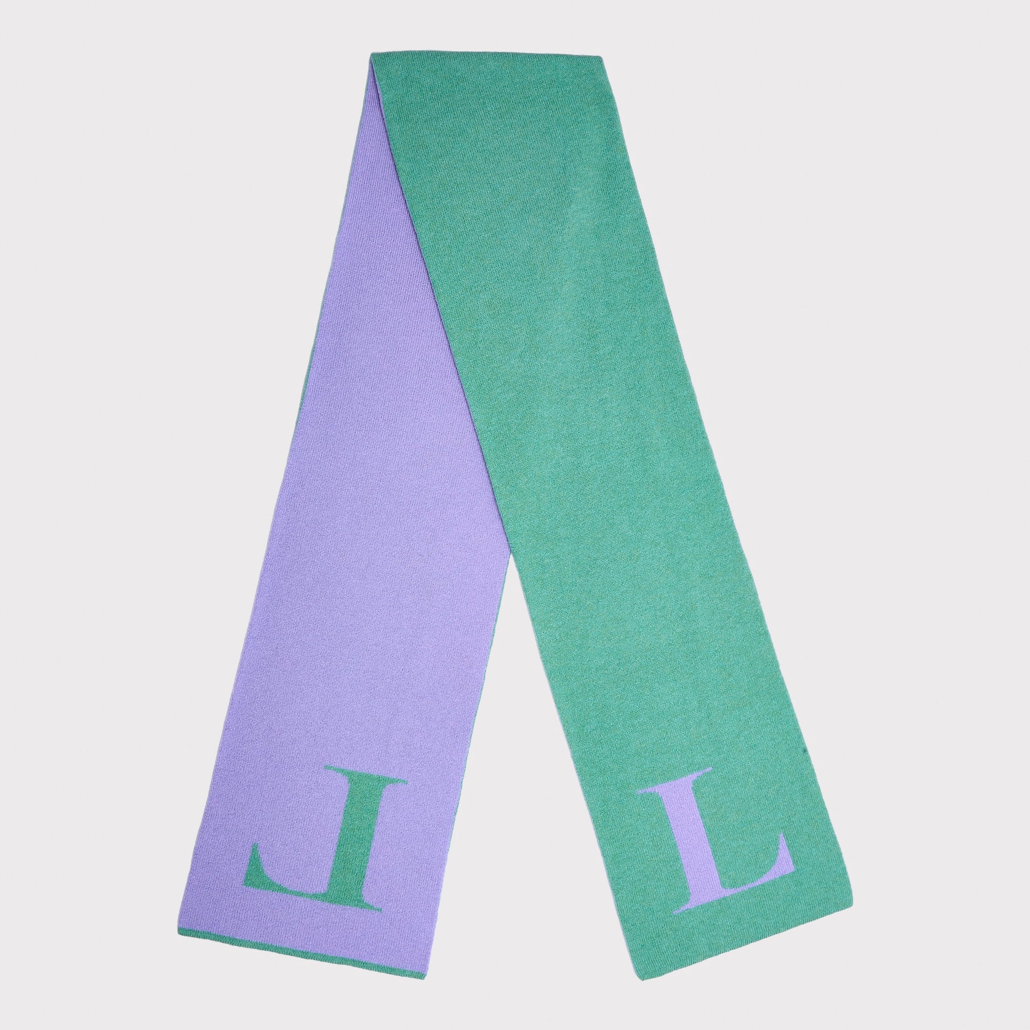 A mint green knit scarf with a large lavender letter 'L' on each end, laid flat in half shown against a light grey background.
