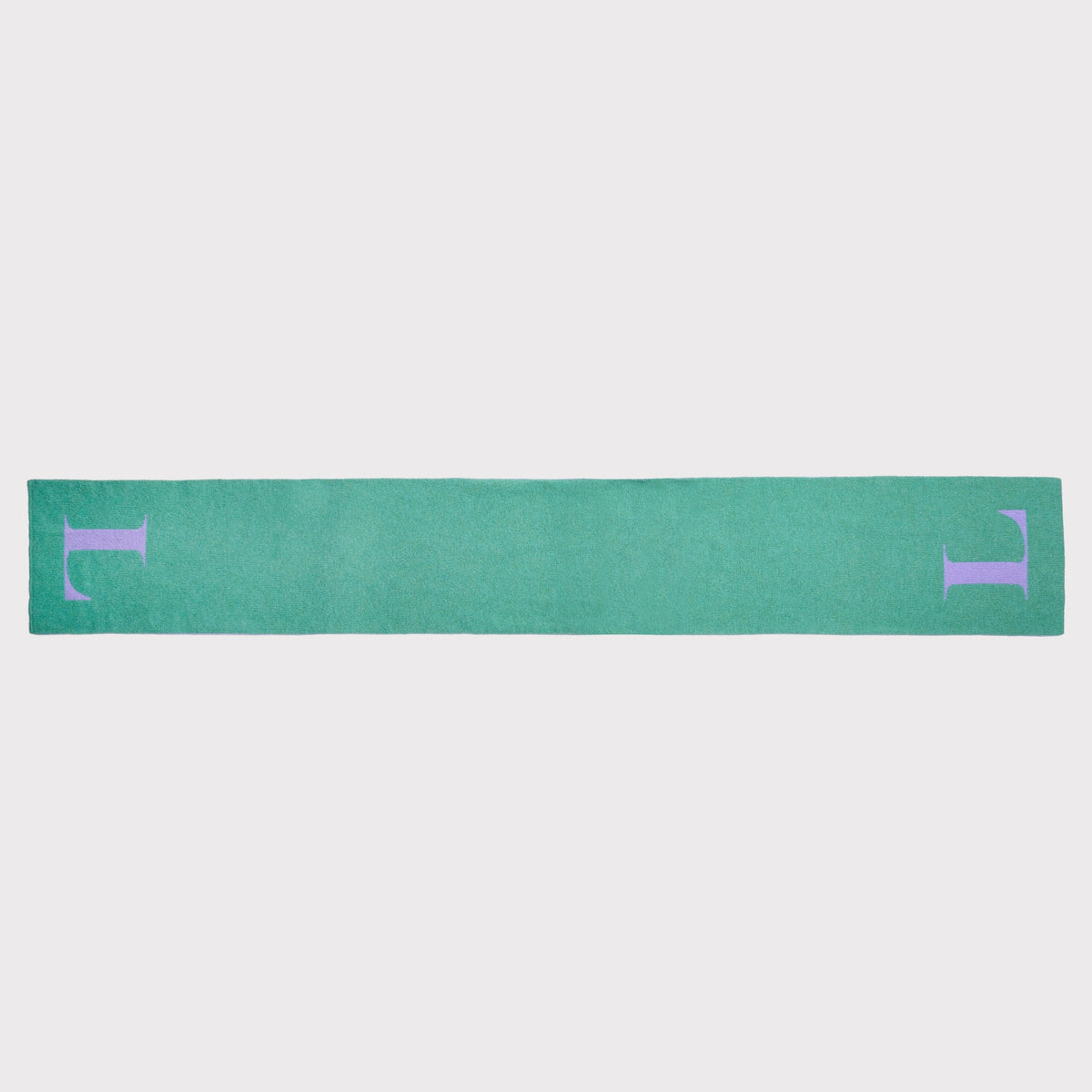 A mint green knit scarf with a large lavender letter 'L' on each end, shown laid flat against a light grey background.