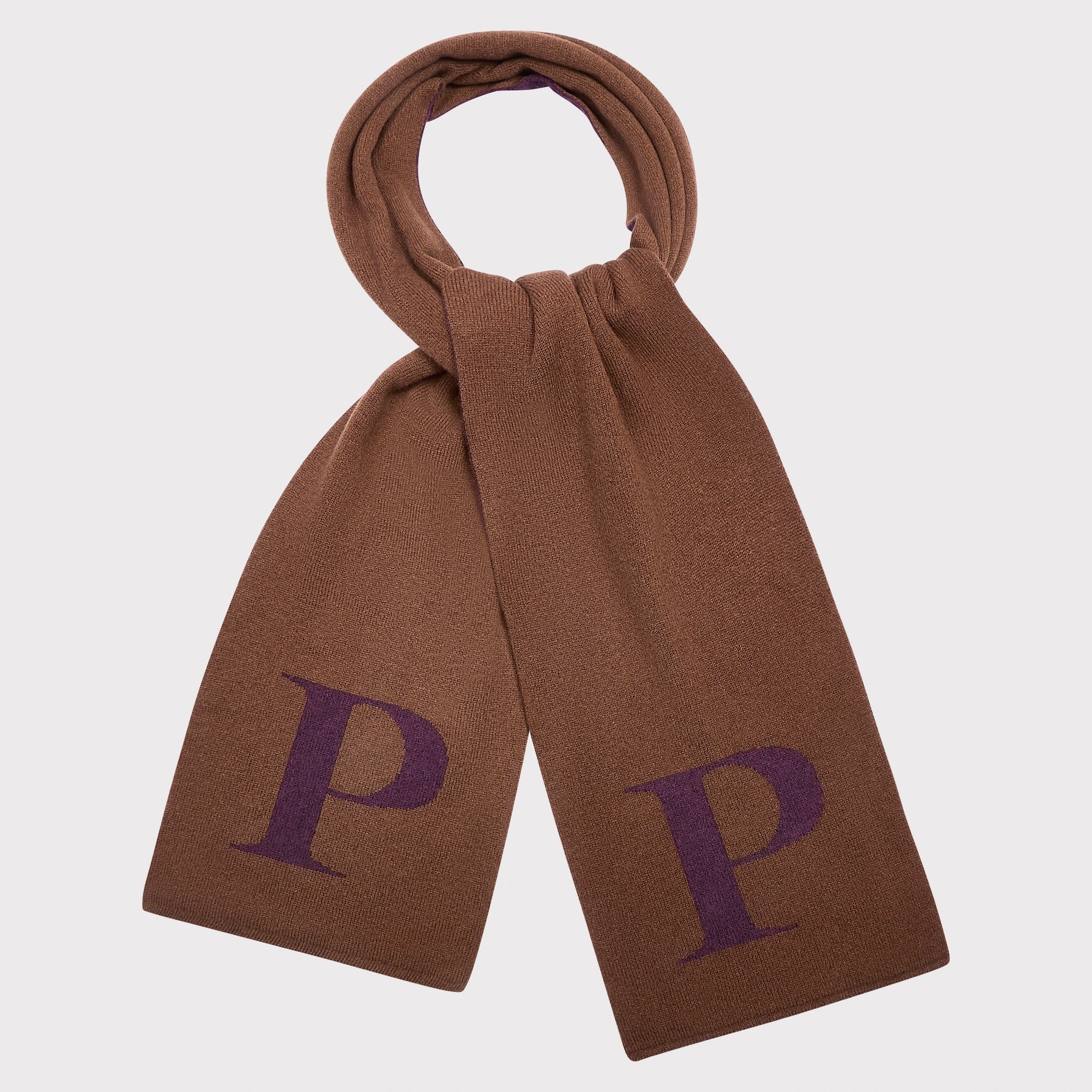 A brown knit scarf with a large purple letter 'P' knitted onto each end, shown looped at the top against a light grey background.