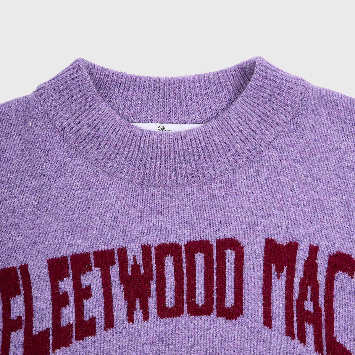 Close-up of the purple knit Albatross knit with 'FLEETWOOD MAC' arched in dark red lettering across the chest.