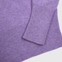 Close-up of the Albatross knit, showing the ribbed cuff and sleeve detail against a plain light grey background.