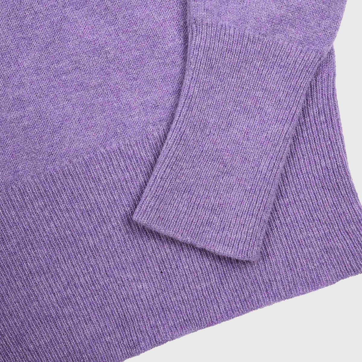 Close-up of the Albatross knit, showing the ribbed cuff and sleeve detail against a plain light grey background.