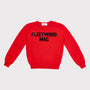 A bright red crewneck sweater with 'FLEETWOOD MAC' knitted in black across the chest, displayed flat against a light grey background.