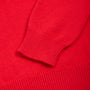 Close-up of the Fleetwood Mac bright red knit garment showing the ribbed cuff of a sleeve and matching ribbed fabric texture.