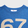 Close-up of the 1967 blue Fleetwood Mac knit with a cream-coloured number 67.