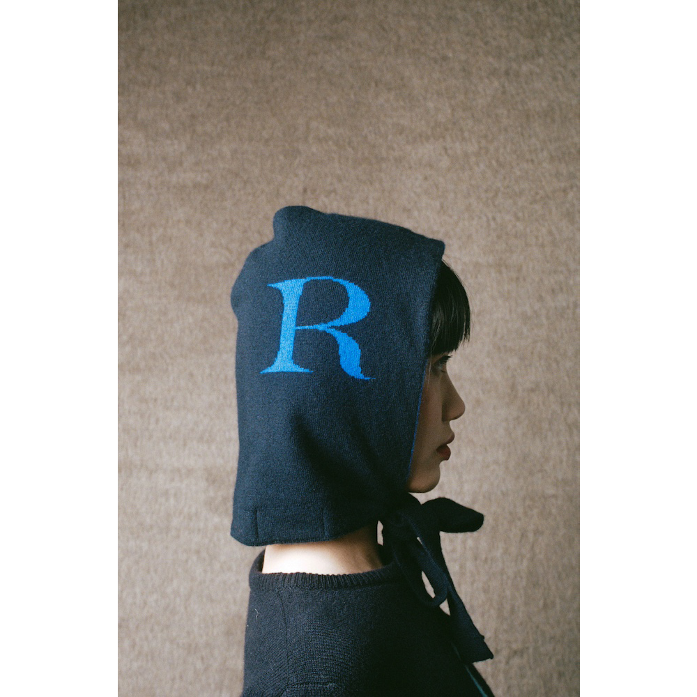 Model wearing HADES R letter hood
