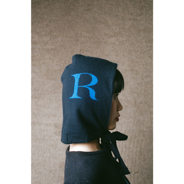 Model wearing HADES R letter hood