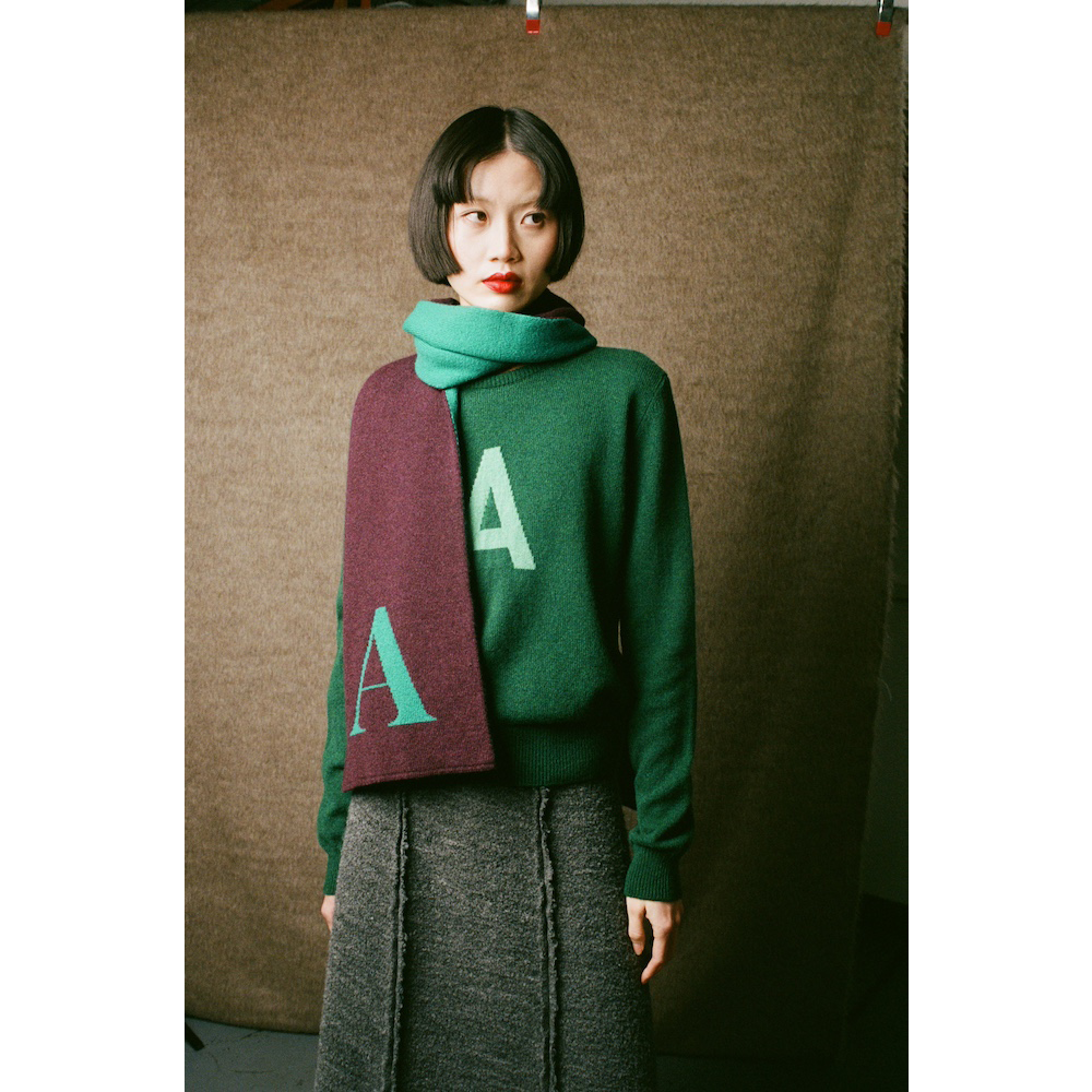 Model wearing HADES Alphabet letter A scarf and A jumper