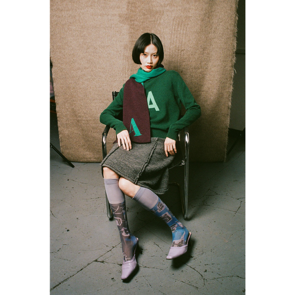 Model wearing HADES Alphabet letter A scarf and A jumper
