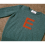 HADES caspian jumper with a red letter 'E' 