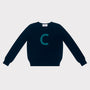 HADES Navy blue knit  with a turquoise letter 'C' 
