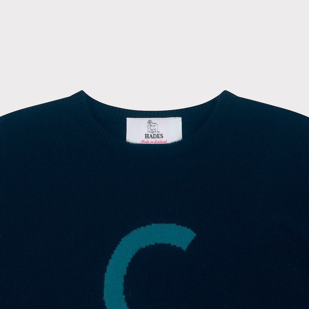 HADES Navy blue knit  with a turquoise letter 'C' necklabel