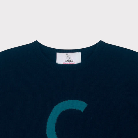 HADES Navy blue knit  with a turquoise letter 'C' necklabel