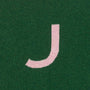 HADES green jumper with a pink letter 'J'  detail