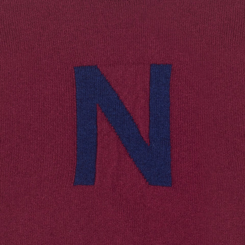 HADES burgundy jumper with a blue letter 'N' detail