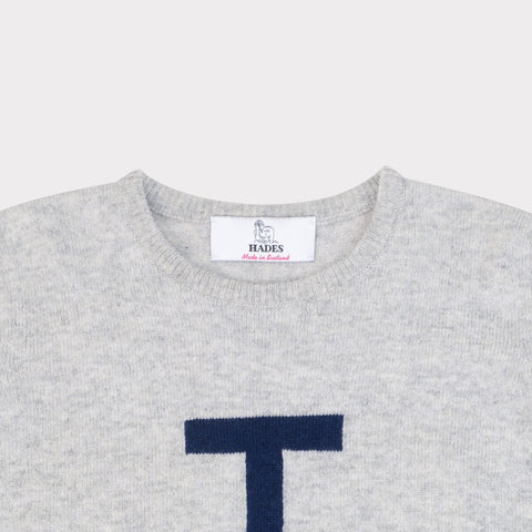 HADES grey sweater with a navy blue letter 'T' necklabel
