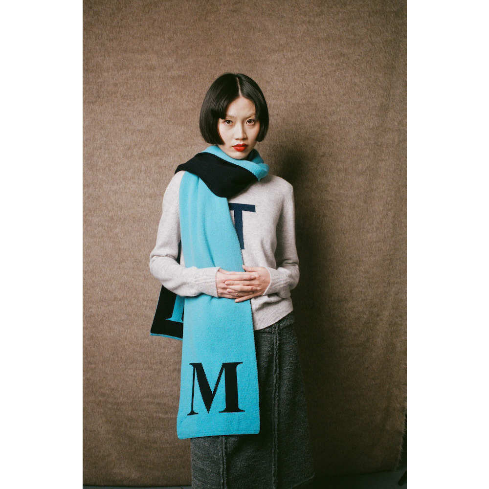 Model wearing HADES letter M scarf 