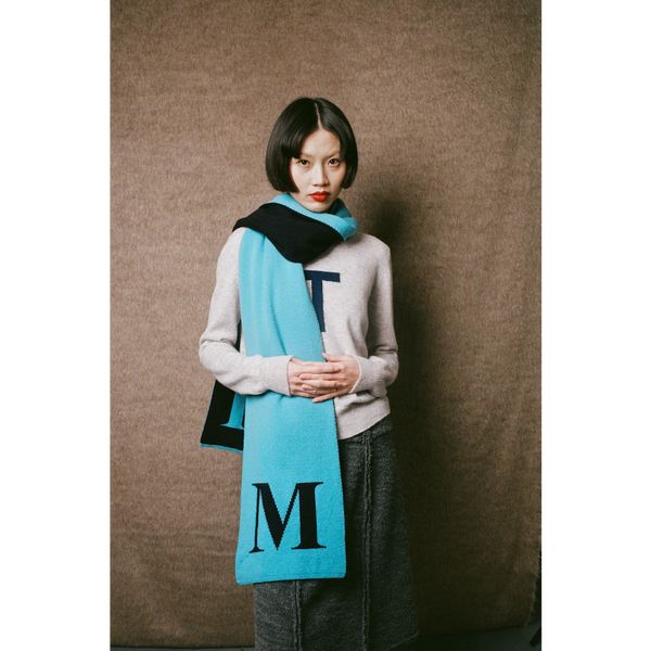Model wearing HADES letter M scarf 