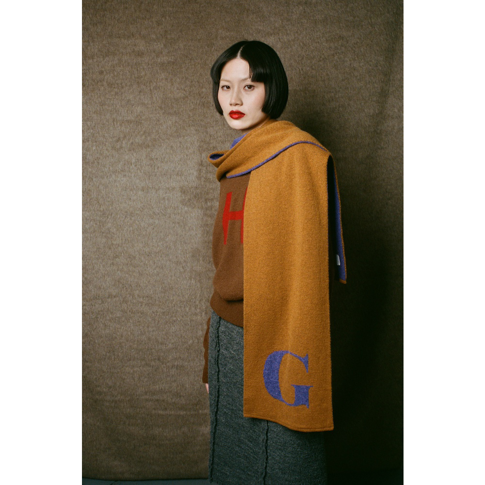 Model wearing HADES G letter scarf