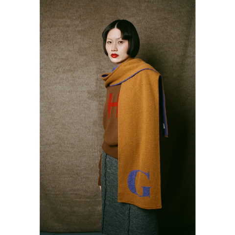 Model wearing HADES G letter scarf