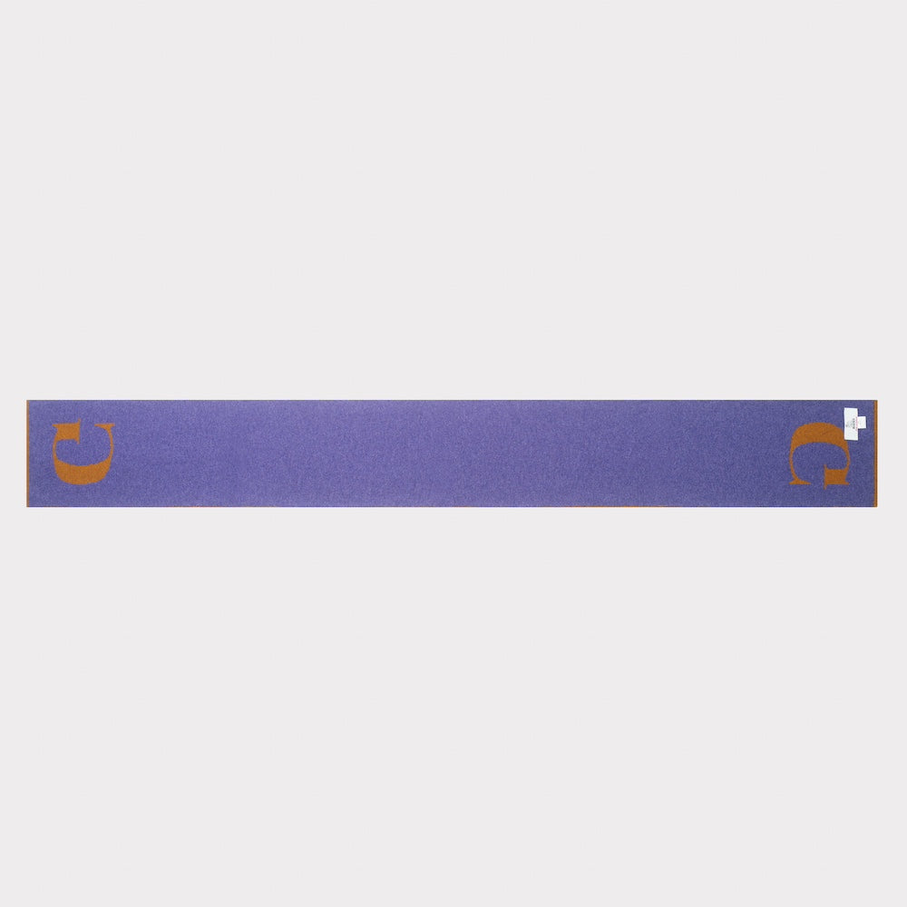 The HADES G letter scarf in bronze and plum laid flat, back view