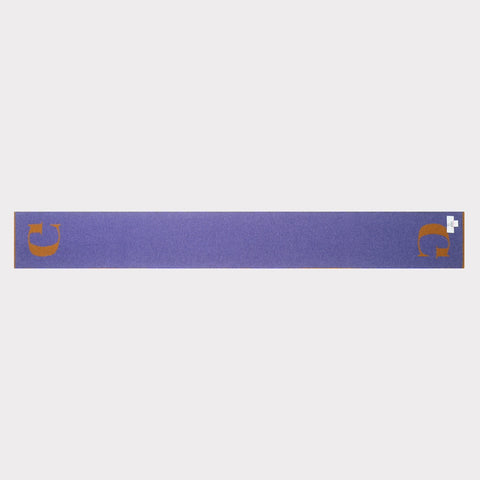 The HADES G letter scarf in bronze and plum laid flat, back view