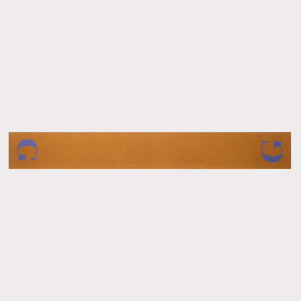 The HADES G letter scarf in bronze and plum laid flat, front view